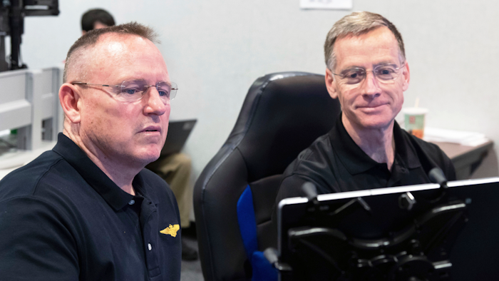Butch Wilmore, left, and Chris Ferguson participate in a flight control simulation for a Boeing CST-100 Starliner capsule at the Johnson Space Center in Houston, Nov. 29, 2018.
