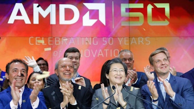 In this May 1, 2019, file photo, Lisa Su, second from right, president and CEO of AMD, attends the opening bell at Nasdaq to celebrate its 50th anniversary in New York. AMD is buying processing platform developer Xilinx in an all-stock deal valued at $35 billion.