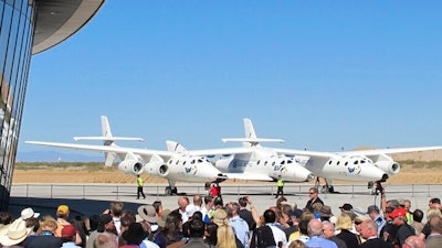A crowd gathers outside Spaceport America for a dedication ceremony.