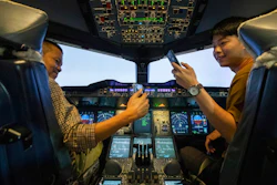 Customers take selfie photos in an Airbus A380 flight simulator.