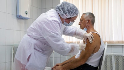 A Russian medical worker administers a shot of Russia's experimental Sputnik V coronavirus vaccine in Moscow, Russia.