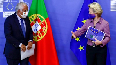 Portugal's Prime Minister Antonio Costa, left, is welcomed by European Commission President Ursula von der Leyen prior to a meeting at EU headquarters in Brussels.