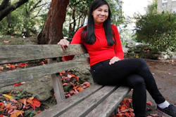 Danica Marcos, sits in a park in London, Friday, Oct. 16, 202. Danica Marcos a volunteer as U.K. researchers are preparing to begin a controversial experiment that will infect healthy volunteers with the new coronavirus to study the disease in hopes of speeding up development of a vaccine.