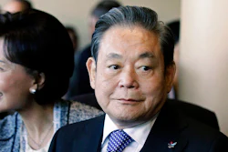 Samsung Chairman Lee Kun-hee, right, greets people from the South Korean delegation in Durban, South Africa.