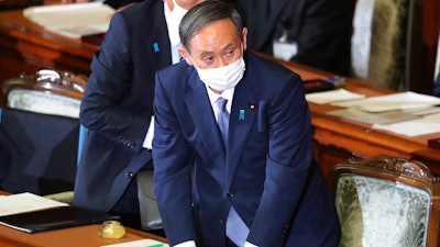 Japanese Prime Minister Yoshihide Suga attends an extraordinary Diet session to deliver his policy speech at the upper house of parliament in Tokyo.