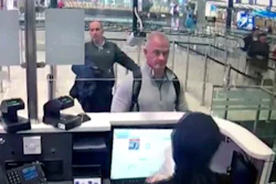 Image from security camera video showing Michael L. Taylor, center, and George-Antoine Zayek at passport control at Istanbul Airport in Turkey, Dec. 30, 2019.