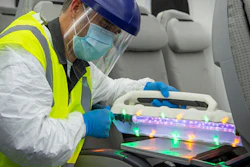 A Boeing employee uses the UV wand on an area with MS2.