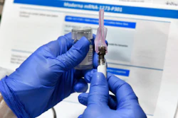 Nurse Kathe Olmstead prepares a shot for part of a possible COVID-19 vaccine, Binghamton, N.Y., July 27, 2020.