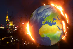A makeshift globe burns in front of the European Central Bank in Frankfurt, Germany, Oct. 21, 2020.
