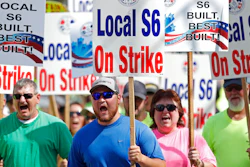 Striking Bath Iron Works shipbuilders march in solidarity.