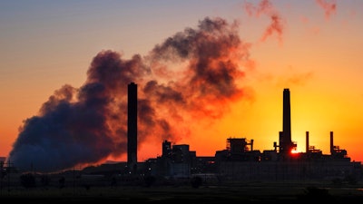 The Dave Johnson coal-fired power plant is silhouetted against the morning sun in Glenrock, Wyo.