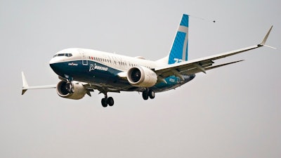 In this Wednesday, Sept. 30, 2020, file photo, a Boeing 737 Max jet, piloted by Federal Aviation Administration Chief Steve Dickson, prepares to land at Boeing Field following a test flight in Seattle. The FAA is poised to clear the Boeing 737 Max to fly again after grounding the jets for nearly two years due to a pair of disastrous crashes that killed 346 people.