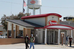 In this May 7 file photo, workers enter and leave the Tyson Foods pork processing plant in Logansport, IN.