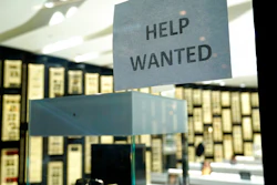 A Help Wanted sign is posted at a Designer Eyes store at Brickell City Centre in Miami.