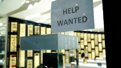 A Help Wanted sign is posted at a Designer Eyes store at Brickell City Centre in Miami.