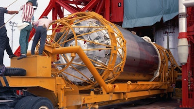 In this Aug. 13, 1965 photo provided by the San Diego Air and Space Museum, technicians work on an Atlas Centaur 7 rocket at Cape Canaveral, Fla. A mysterious object temporarily orbiting Earth is a Centaur 7 upper stage rocket, not an asteroid after all, astronomers confirmed Wednesday, Dec. 2, 2020.