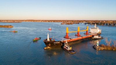 Tugboats work to free the freighter Harvest Spirit that turned sideways and grounded in the Livingstone Channel of the Detroit River.