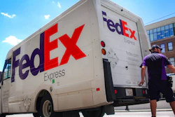 A FedEx delivery truck is loaded by an employee on the street in downtown Cincinnati.