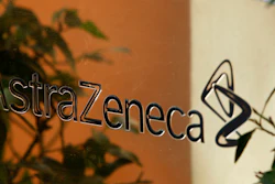 In this Jan. 29, 2009 file photo, reflections are seen on a sign outside the global headquarters of AstraZeneca in London. Cambridge, England-based pharmaceutical company AstraZeneca, which is involved in development of a COVID-19 vaccine, said Saturday Dec, 12, 2020, it is acquiring Boston-based drug developer Alexion Pharmaceuticals Inc. in a deal worth dollars 39 billion.