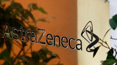 In this Jan. 29, 2009 file photo, reflections are seen on a sign outside the global headquarters of AstraZeneca in London. Cambridge, England-based pharmaceutical company AstraZeneca, which is involved in development of a COVID-19 vaccine, said Saturday Dec, 12, 2020, it is acquiring Boston-based drug developer Alexion Pharmaceuticals Inc. in a deal worth dollars 39 billion.