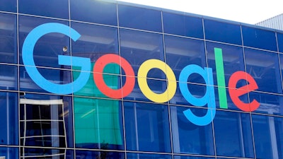 In this Sept. 24, 2019, file photo a sign is shown on a Google building at their campus in Mountain View, Calif. Google is formally pushing back on antitrust claims brought against it by the Justice Department two months ago. In a legal filing with the U.S. District Court for the District of Columbia, Google generally denied the legal claims against it and said that people use its search engine “because they choose to, not because they are forced to or because they cannot easily find alternative ways to search for information on the Internet.”