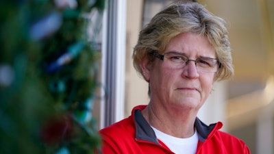 Keli Paaske stands outside her home in Olathe, Kan. Friday, Dec. 4, 2020. Paaske was laid off in August from a company supplying fire doors to hospitals after being furloughed for five months and has struggled to find a new job.