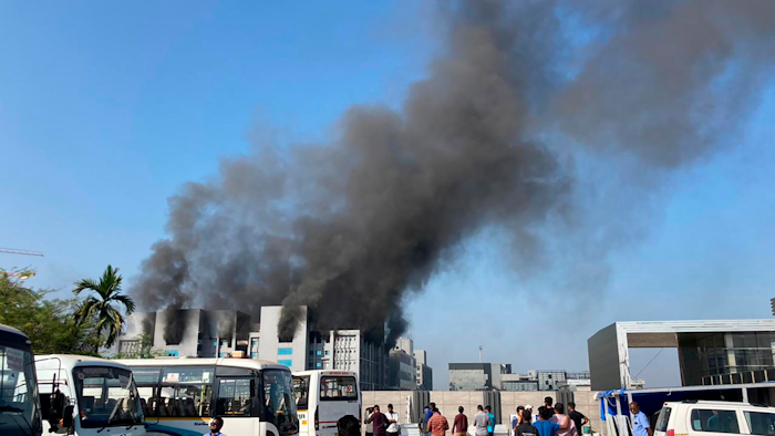 Smoke rises from the Serum Institute of India, the world's largest vaccine maker that is manufacturing the AstraZeneca/Oxford University vaccine for the coronavirus, in Pune, India, Thursday, Jan. 21, 2021.