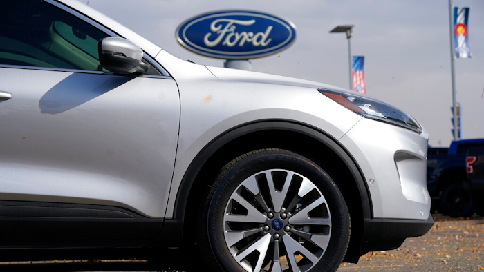 In this Sunday, Oct. 11, 2020 file photo, A row of 2020 Ford Escape sports-utility vehicles sits at a Ford dealership in Denver. A widening global shortage of semiconductors for auto parts is forcing major auto companies to halt or slow vehicle production just as they were recovering from pandemic-related factory shutdowns. Ford had scheduled down time next week at its Louisville, Kentucky, assembly plant, but moved it ahead to this week. The plant makes the Ford Escape and Lincoln Corsair small SUVs.