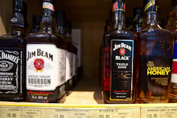 In this July 7, 2018 file photo, whiskeys distilled and bottled in the U.S. are displayed for sale in a grocery store in Beijing.