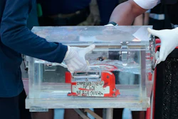 Members of the National Transportation Safety Committee carry a box containing the flight data recorder from the Sriwijaya Air flight SJ-182 retrieved from the Java Sea where the passenger jet crashed at the Tanjung Priok Port, Tuesday, Jan. 12, 2021. Indonesian navy divers searching the ocean floor on Tuesday recovered the flight data recorder from a Sriwijaya Air jet that crashed into the Java Sea with 62 people on board, Saturday, Jan. 9, 2021.
