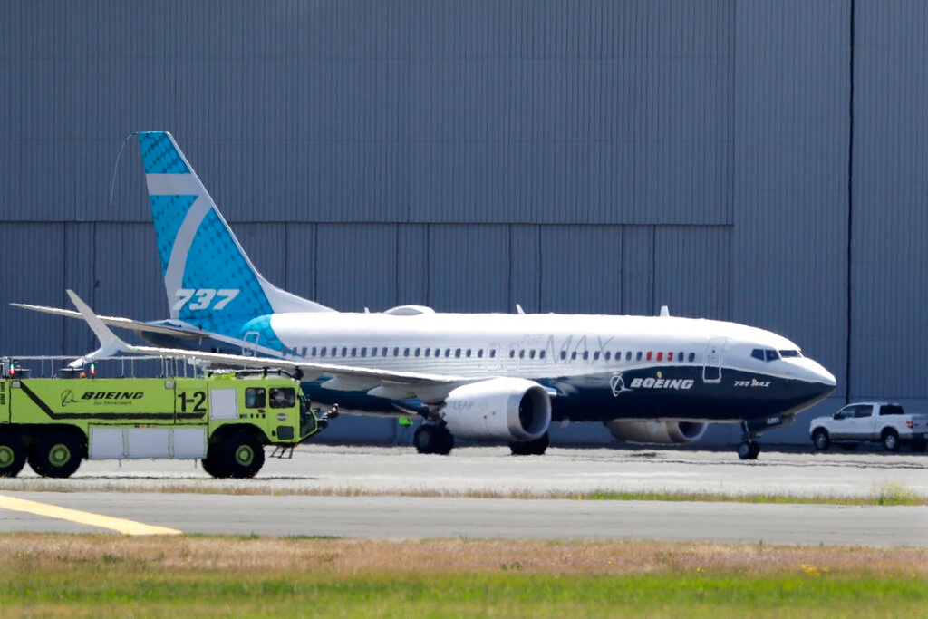 In this Monday, June 29, 2020, file photo, A Boeing 737 MAX jet taxis after landing at Boeing Field following a test flight in Seattle. Boeing will pay $2.5 billion to settle a criminal charge related to its troubled 737 Max jetliner. The Justice Department announced the settlement Thursday, Jan. 7, 2021 nearly two years after the second of two crashes that killed 346 people in all.