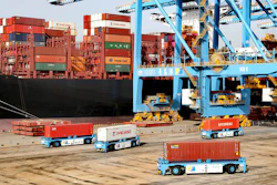 Automated vehicles move shipping containers in a container port in Qingdao in eastern China's Shandong Province. The U.S.-Chinese trade war isn't going away under President Joe Biden.