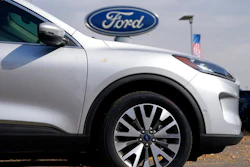 In this Sunday, Oct. 11, 2020 file photo, A row of 2020 Ford Escape sports-utility vehicles sits at a Ford dealership in Denver. A widening global shortage of semiconductors for auto parts is forcing major auto companies to halt or slow vehicle production just as they were recovering from pandemic-related factory shutdowns. Ford had scheduled down time next week at its Louisville, Kentucky, assembly plant, but moved it ahead to this week. The plant makes the Ford Escape and Lincoln Corsair small SUVs.