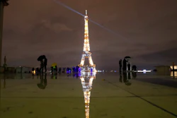 People stroll on the Trocadero square to watch the Eiffel Tower lightings, Friday, Dec. 11, 2020 in Paris.