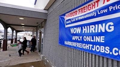 In this Dec. 10, 2020, file photo, a 'Now Hiring' sign hangs on the front wall of a Harbor Freight Tools store in Manchester, N.H. The latest figures for jobless claims, issued Thursday, Jan. 14, 2021 by the Labor Department, remain at levels never seen until the virus struck.