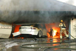 This undated photo provided by National Transportation Safety Board, The Orange County Fire Authority battles a fire on a burning vehicle inside a garage in Orange County, Calif. When firefighters removed the SUV from the garage to assess the fire , they identified the fuel source as the SUV’s high-voltage battery pack. U.S. safety investigators say electric vehicle fires pose risks to first responders, and manufacturers have inadequate guidelines to keep them safe.