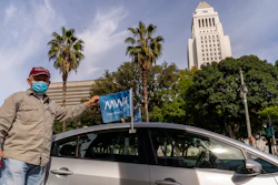 Uber driver Jose Luis Guevara, a member of the Mobile Workers Alliance, pauses for a picture outside Los Angeles City Hall. Drivers for app-based ride-hailing and delivery services are suing to overturn a California ballot initiative.