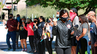 Naelyn Pike leads a prayer outside the federal courthouse in Phoenix, Feb. 2, 2021.