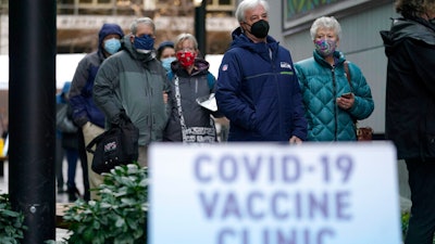 People waiting to receive the first dose of a Pfizer vaccine in Seattle, Jan. 24, 2021.