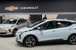 The 2022 Bolt EV, foreground, and EUV are displayed, Thursday, Feb. 11, 2021, in Milford, Michigan.