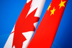 In this Nov. 12, 2018, file photo, flags of Canada and China are placed for the first China-Canada economic and financial strategy dialogue in Beijing, China. China says it has lodged a formal complaint with Canada over T-shirts ordered by one of the country’s Beijing Embassy staff that allegedly mocked China’s response to the coronavirus outbreak.