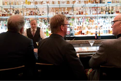 In this file photo, a bartender talks to a customer at the Gotham Bar and Grill in New York.