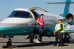 This Aug. 17, 2011 file photo, Jaeger Mah, left, is greeted by Vancouver International Airport CEO Larry Berg, right, and pilot Brent Fishlock as he steps off a Learjet upon arrival at the airport after a short tour in Richmond, B.C. The iconic Learjet, which carried generations of business executives and was made famous in pop songs, is about to fade into aviation history. Canada’s Bombardier said Thursday, Feb. 11, 2021 it will end production of the Learjet later this year.