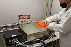 A Northrop Grumman engineer prepares SharkSat for integration with the Cygnus spacecraft.