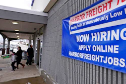 In this Dec. 10, 2020 file photo, a 'Now Hiring' sign hangs on the front wall of a Harbor Freight Tools store in Manchester, N.H. U.S. employers cut back sharply on hiring in December, particularly in pandemic-hit industries such as restaurants and hotels, as soaring virus infections and government restrictions weakened the economy that month. The number of available jobs rose slightly and layoffs fell, according to the Labor Department’s Tuesday report, known as the Job Openings and Labor Turnover Survey, or JOLTS.