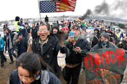 In this Feb. 22, 2017, file photo, a large crowd representing a majority of the remaining Dakota Access Pipeline protesters march out of the Oceti Sakowin camp near Cannon Ball, N.D. After President Joe Biden revoked Keystone XL's presidential permit and shut down construction of the long-disputed pipeline that was to carry oil from Canada to Texas, opponents of other pipelines hoped the projects they've been fighting would be next.