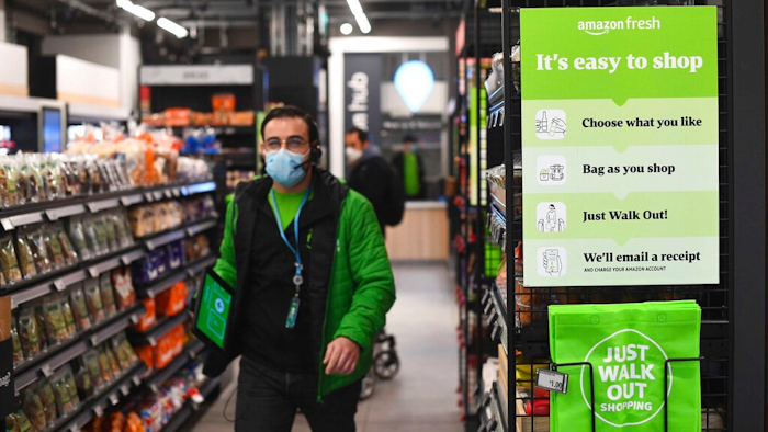The Amazon Fresh grocery store opens in London, Thursday March 4, 2021, where a sign explains for shoppers to pick up items and walk out of the store, contactless, without the need for a till. Customers will scan a QR code on their way into the store, with cameras and technology identifying the items that shoppers take from the shelves and their account automatically paid.