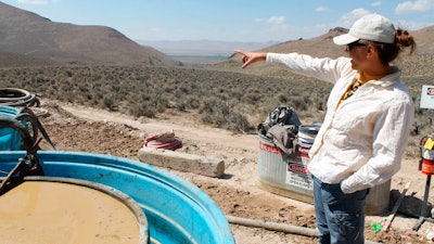 Melissa Boerst, a Lithium Nevada Corp. geologist, points to an area of future exploration from a drill site at the Thacker Pass Project, Humboldt County, Nev., Sept. 13, 2018.