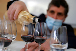 Philippe Darriet, president of the Institute for Wine and Vine Research, fills glasses at the ISVV Institute in Villenave-d'Ornon, France, March 1, 2021.