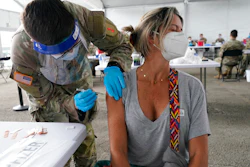 Liana Fonseca looks away as she receives the Pfizer COVID-19 vaccine in Miami, March 9, 2021.